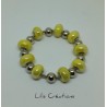 Bracelet en perles jaunes et argentés montées sur fil ressort en métal