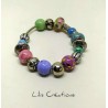 Bracelet en perles tons bleu, rose, vert et argenté montées sur fil ressort en métal