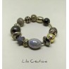 Bracelet en perles tons noir, gris et argenté montées sur fil ressort en métal